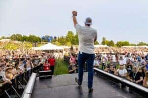 Jeff Belzer on stage facing crowd at Lakefront Music Fest