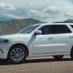 2022 white dodge durango parked on road with mountains in distance