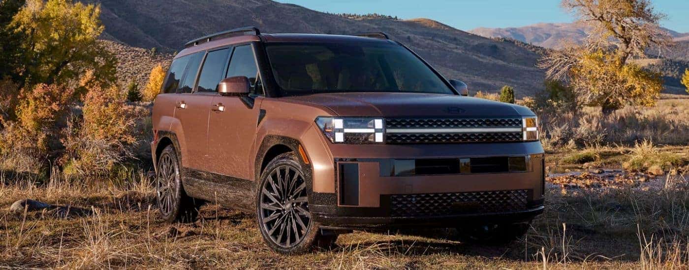 Brown 2026 Hyundai Santa Fe parked off-road.