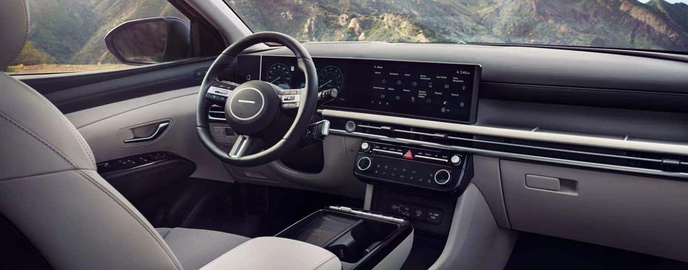 Interior view of the infotainment display and steering wheel on a 2026 Hyundai Tuscon.