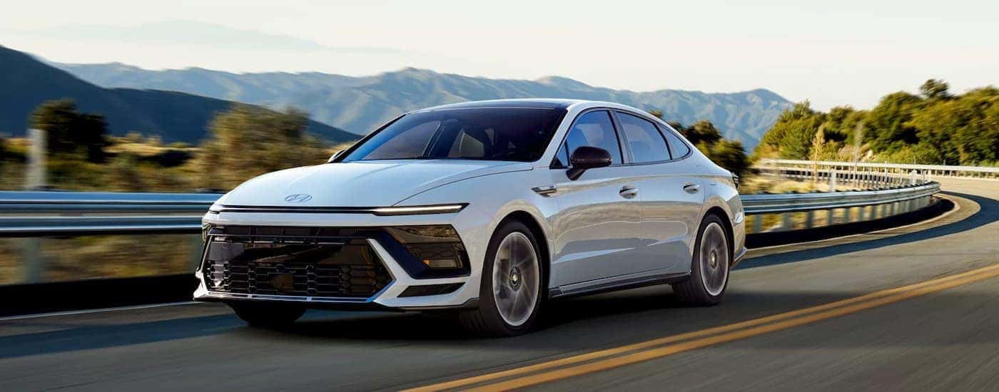 A white 2026 Hyundai Sonata driving on a highway