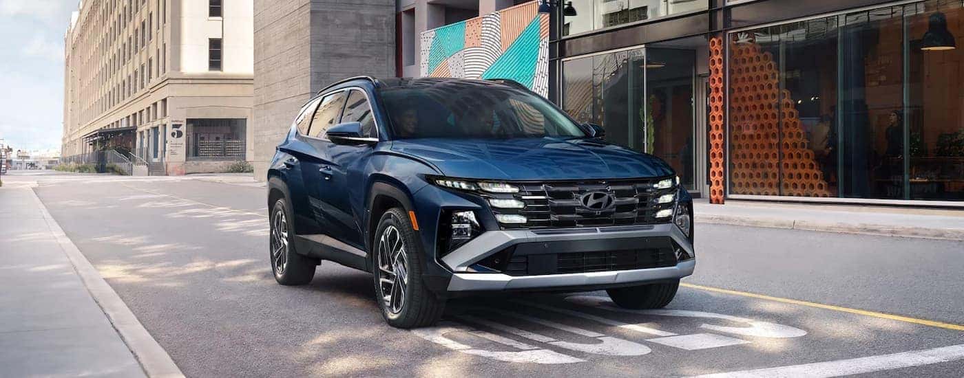 A blue 2026 Hyundai Tucson parked at an intersection