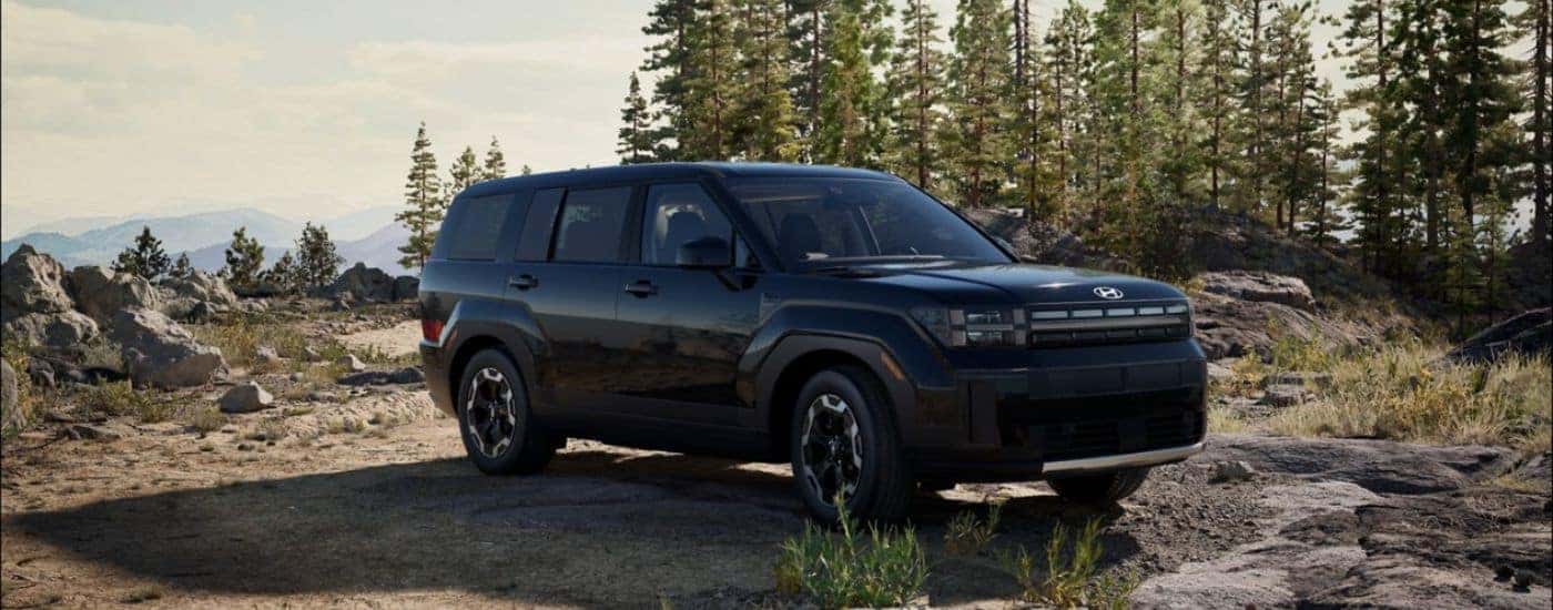 Black 2026 Hyundai Santa Fe SE parked on top of a mountain.