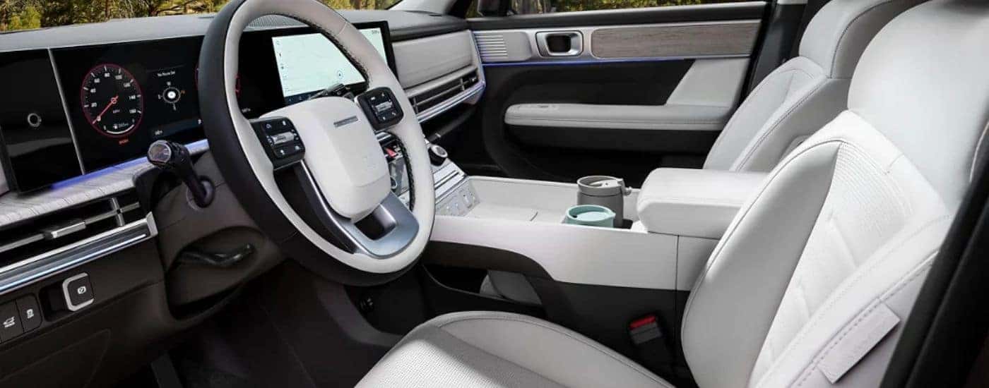 2026 Hyundai Santa Fe white interior of the driver's seat and steering wheel.