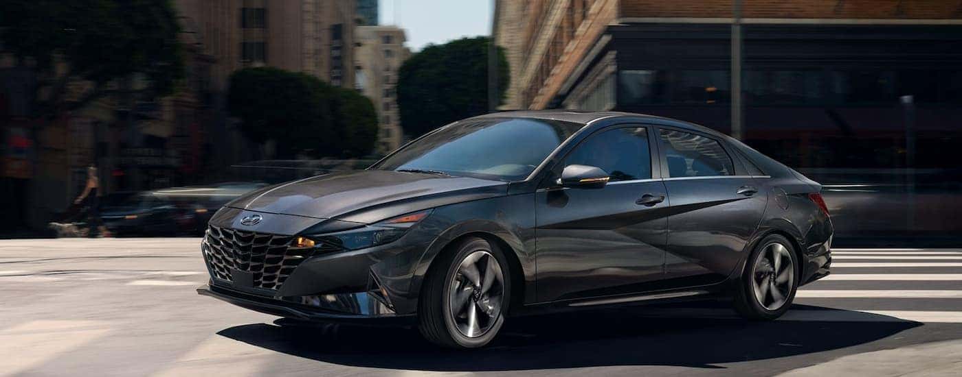 A gray 2022 Hyundai Elantra shown turning a city corner.
