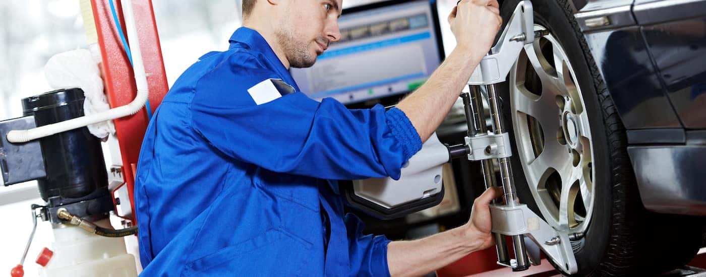 Wheel Alignment service being performed by a mechanic.