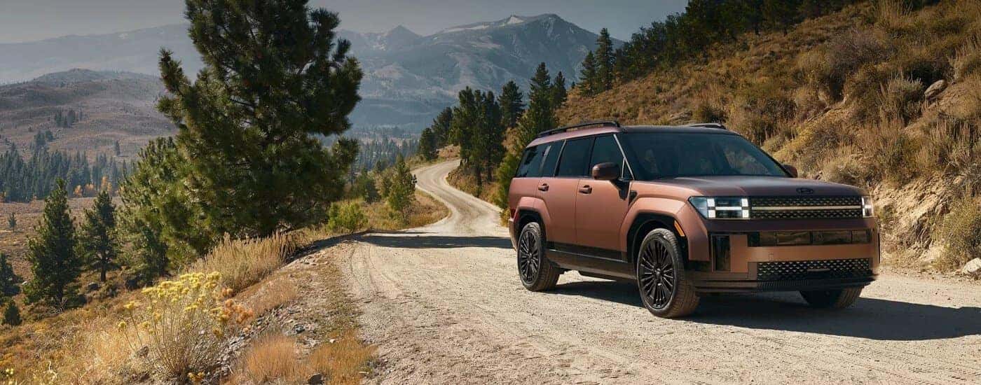 A brown 2025 Hyundai Santa Fe parked off-road