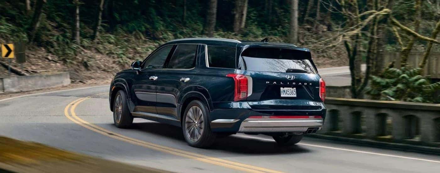 A blue 2023 Hyundai Palisade turning a corner.