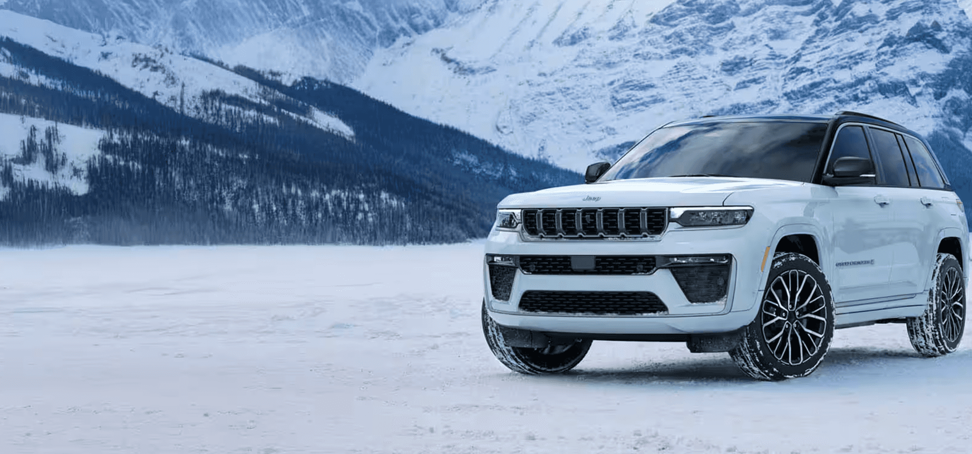 2026 Jeep Grand Cherokee in snowy mountain landscape