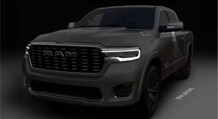 Gray RAM 1500 in a dark studio with its LED headlamps and light bar illuminated