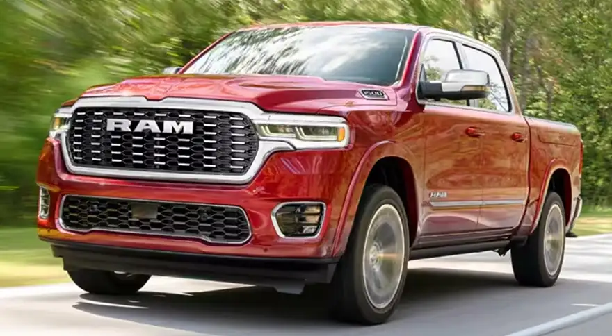 Red RAM 1500 driving on a country road, front three-quarter view showing the grille and fender flares