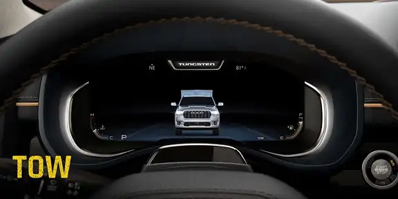 RAM digital cluster display showing the truck graphic with Tow drive mode selected