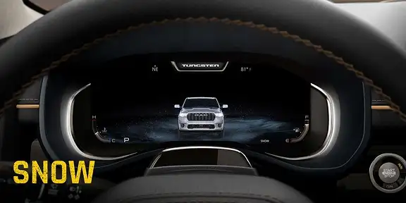 RAM digital cluster display showing the truck graphic with Snow drive mode selected