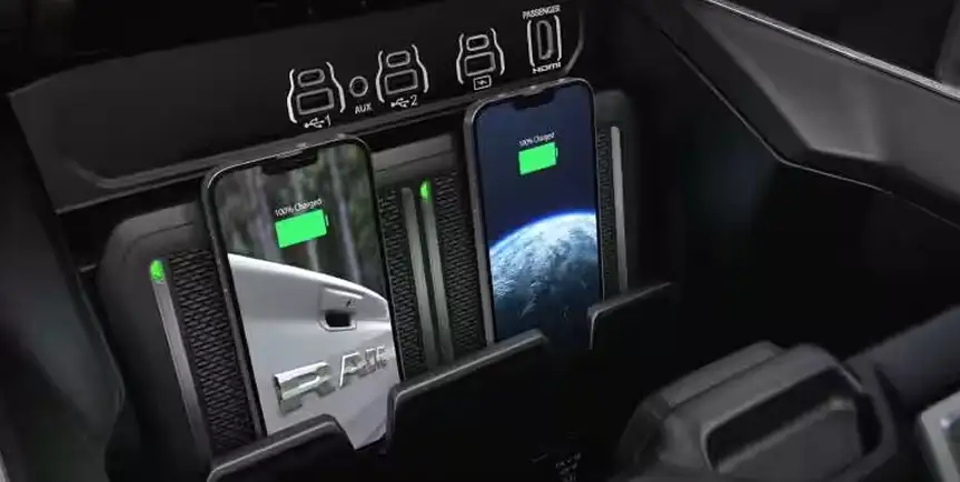Two smartphones charging on the dual wireless charging pads in the RAM 1500 console