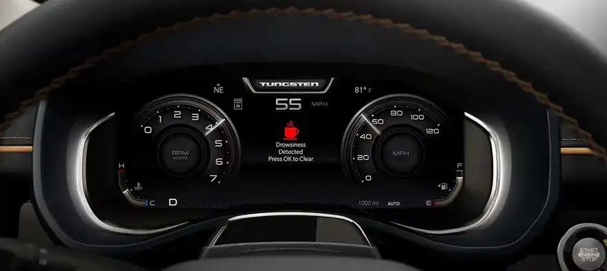 RAM digital cluster showing a red drowsy-driver alert icon between the gauges
