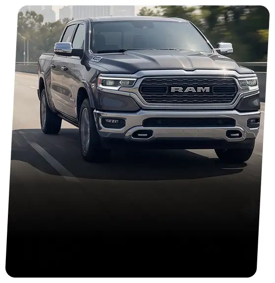 Gray RAM 1500 crew cab pickup shown from the front on a dark road