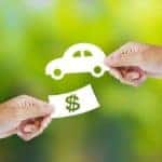 Hand with paper money and car shape new car buy concept