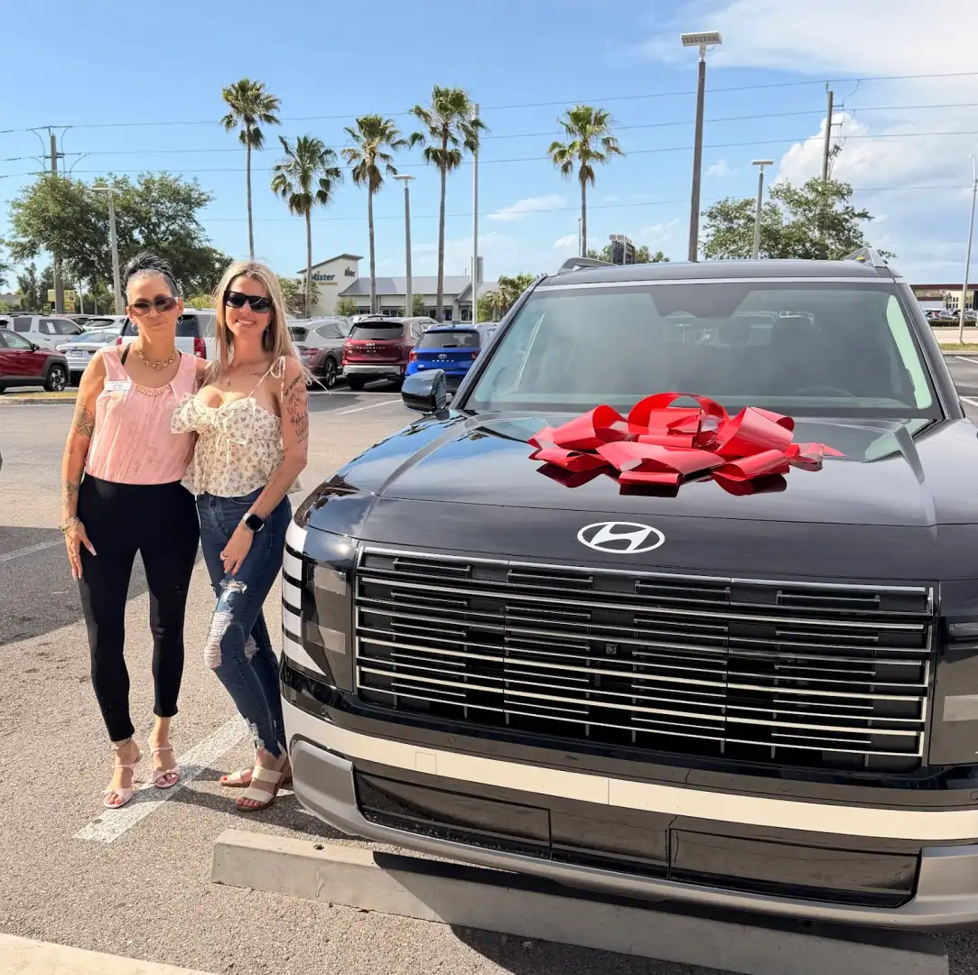 Happy Customers in front of hyunda of fort myers with new hyundai santa fe