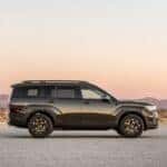 The-right-side-view-of-the-Hyundai-SANTA-FE-XRT-stopped-with-the-mountains-under-the-sunset-in-the-background