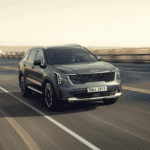 2025 grey kia sorrento driving on road with blurred background