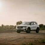 white suv on brown field during daytime
