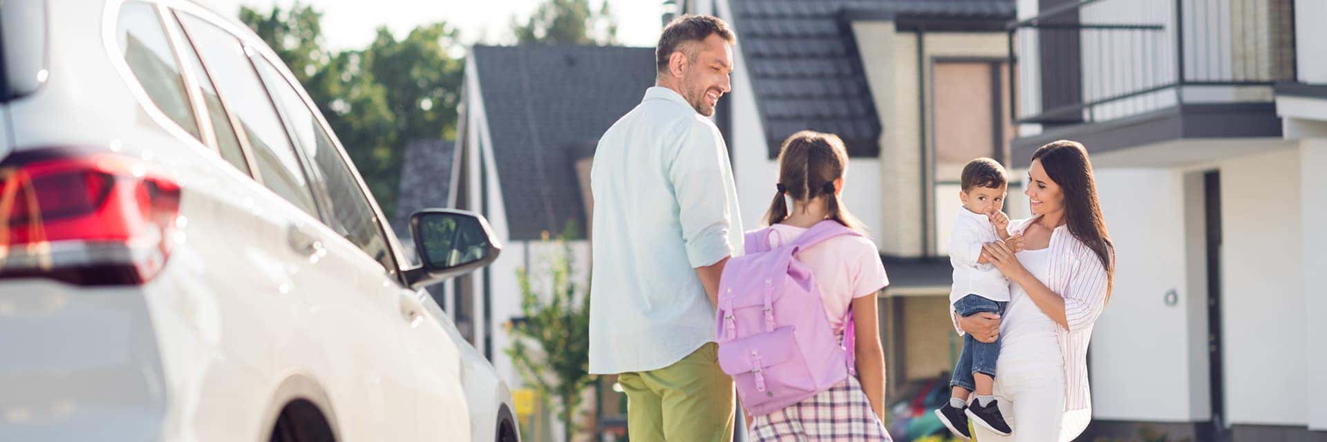 happy family back to school next to car