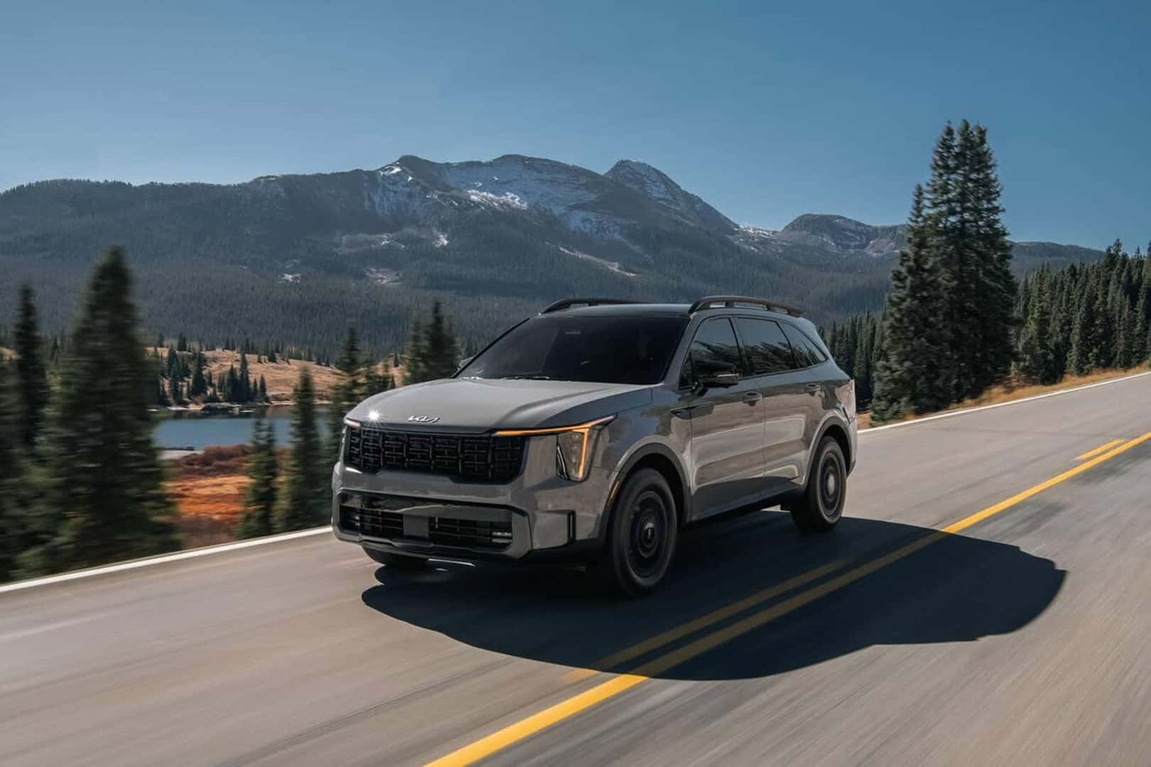 2026 kia sorento driving on road with mountain background