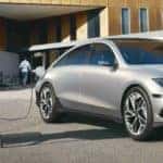 person sitting next to Hyundai IONIQ 6