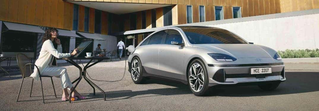 person sitting next to Hyundai IONIQ 6