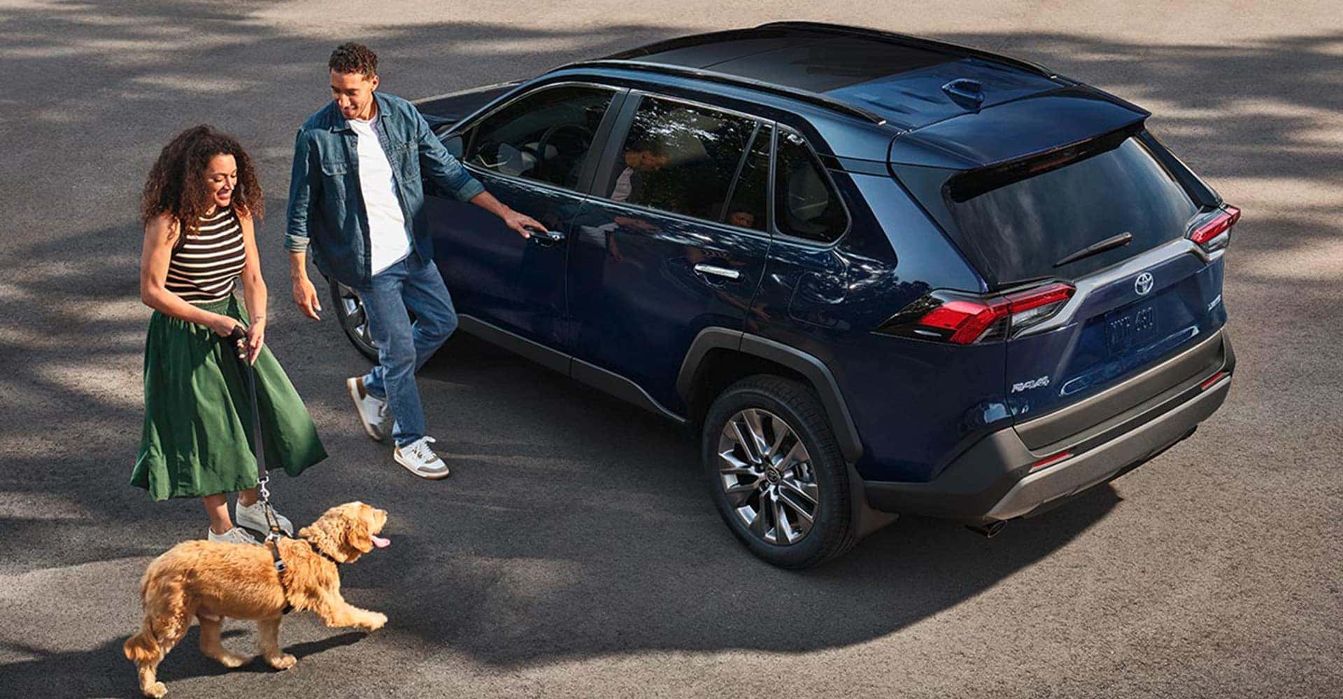 couple getting inside rav4 with their dog