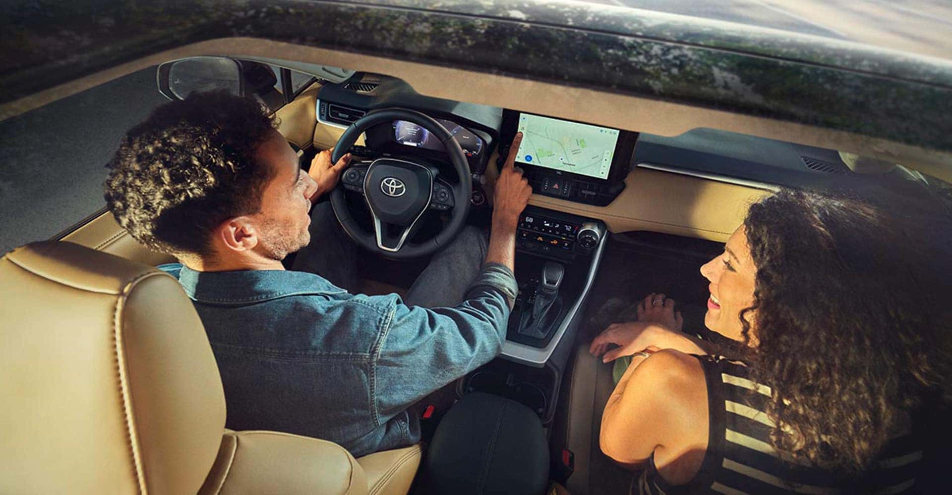 view through sunroof of couple in rav4