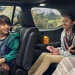 Family buckling up in back of Toyota Grand Highlander