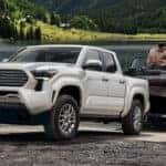 Couple unloading boat from trailer hooked to 2026 tacoma