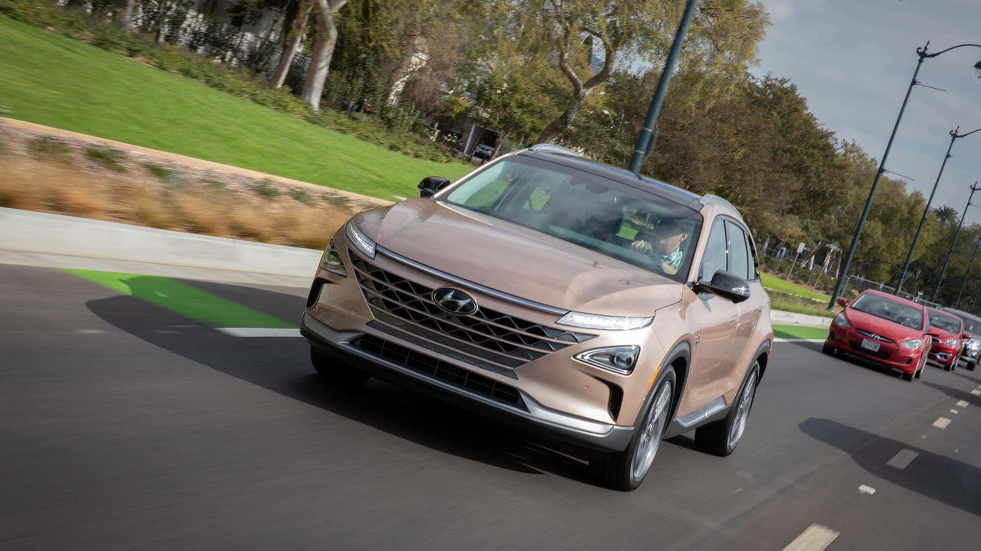 Brown 2025 Hyundai NEXO Fuel Cell Driving Down the Street