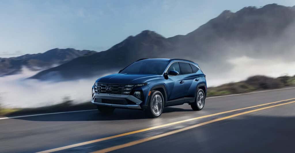 2026-hyundai-tucson-on-road-with-mountains