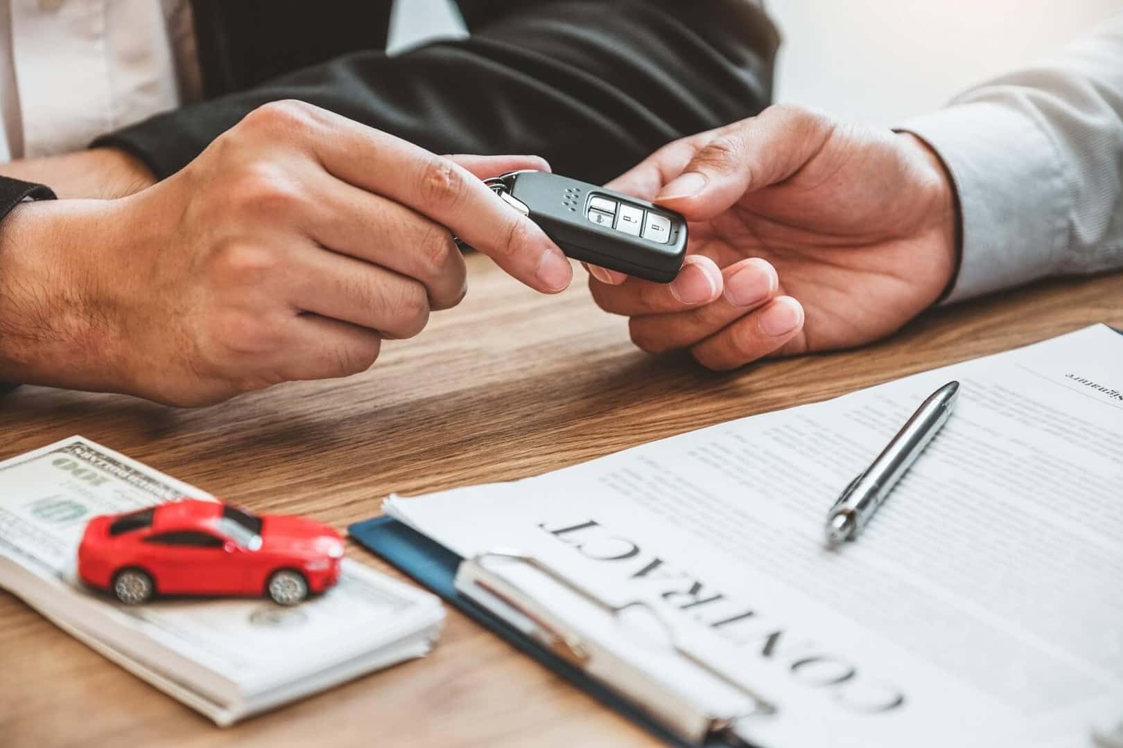 Dealership handing car keys to customer