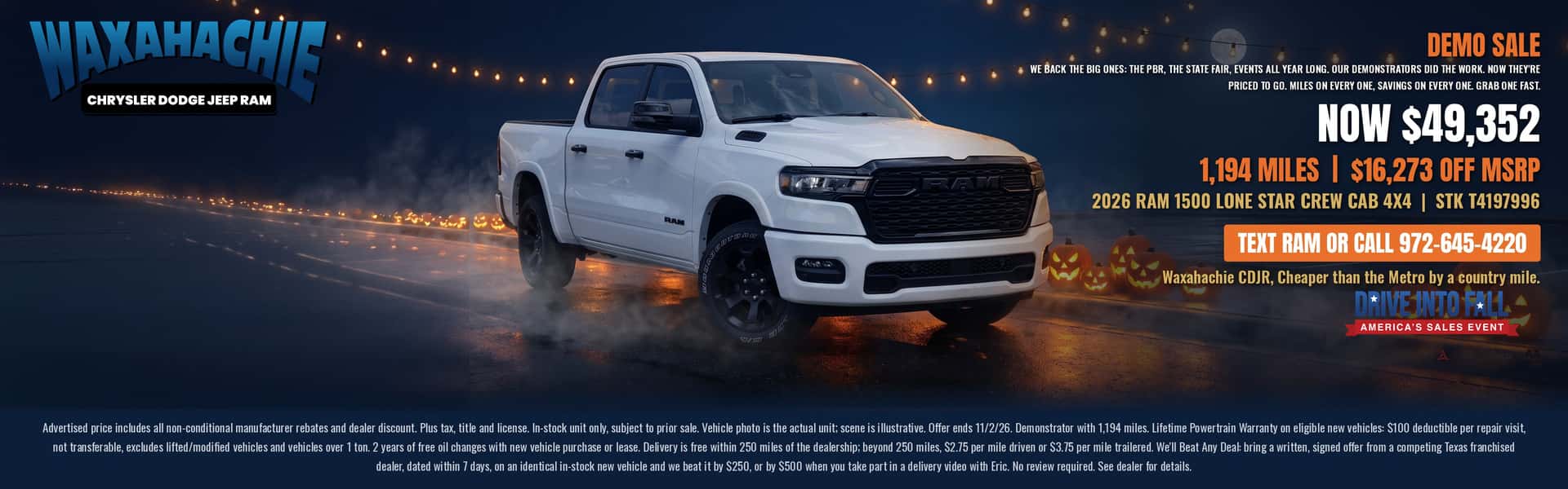 White 2026 Ram 1500 Lone Star Crew Cab 4x4 demo truck on a misty road lined with glowing jack-o-lanterns, Waxahachie Chrysler Dodge Jeep Ram. Now $49,352. Text RAM or call 972-645-4220