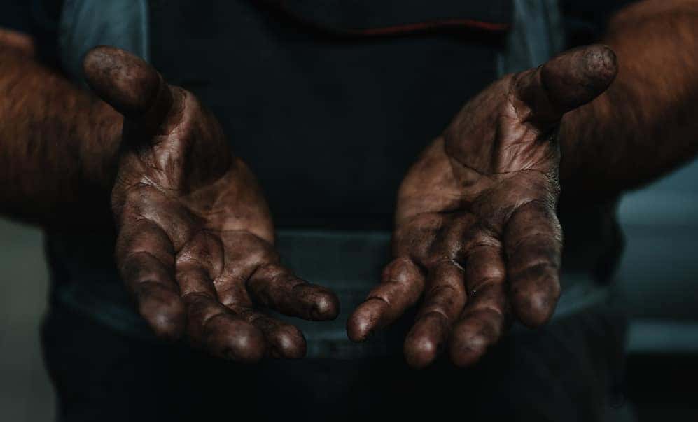 Benefits of Changing Your Chrysler Dodge Jeep Ram’s Oil at Winner's Circle CDJR in Hampton VA | Service Tech with Hands Covered with Sludge
