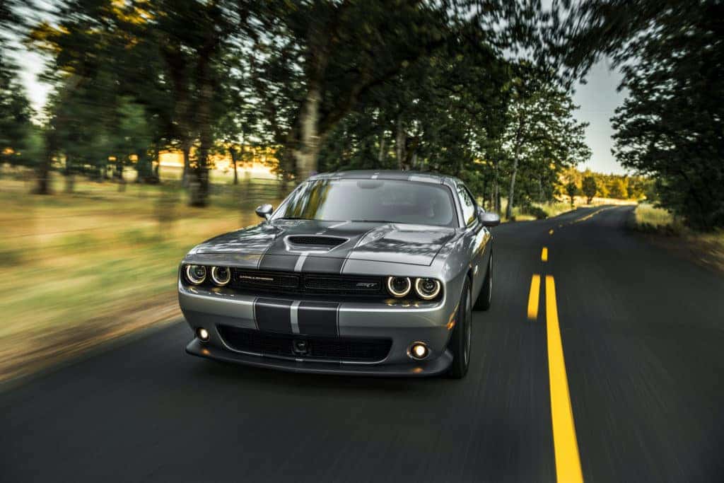 What different tire options are available at Winners Circle Chrysler, Dodge, Jeep, Ram in Hampton? | 2020 Dodge Challenger driving on country road