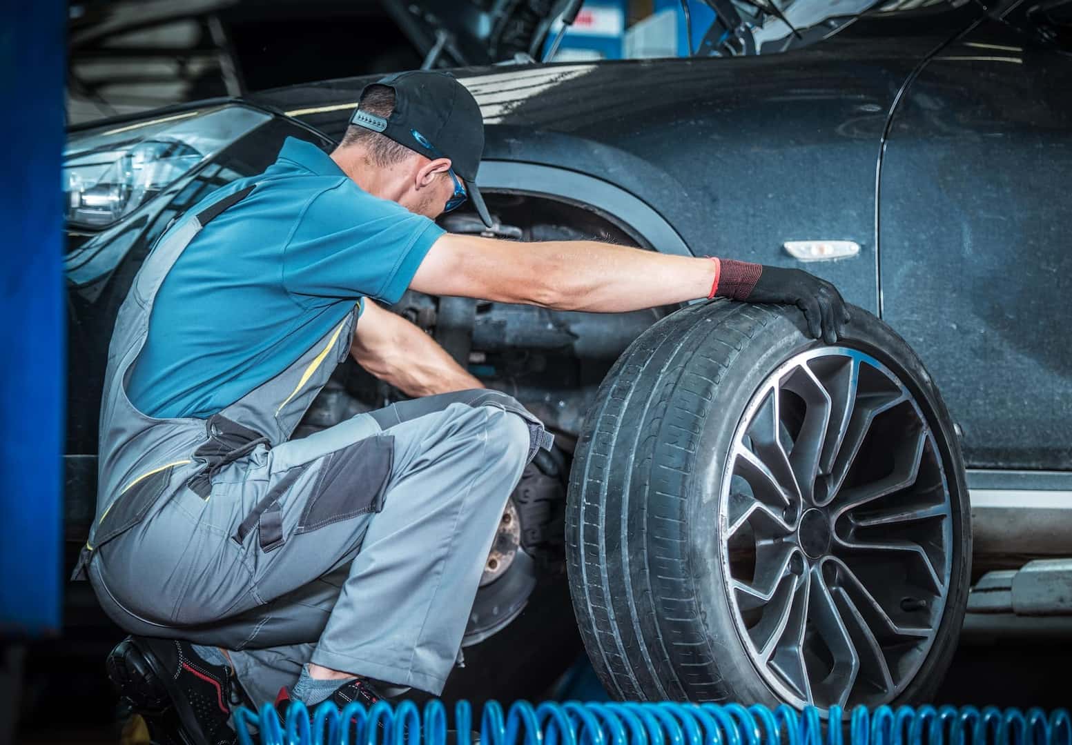 What different tire options are available at Winners Circle Chrysler, Dodge, Jeep, Ram in Hampton? | Mechanic replacing tire on vehicle